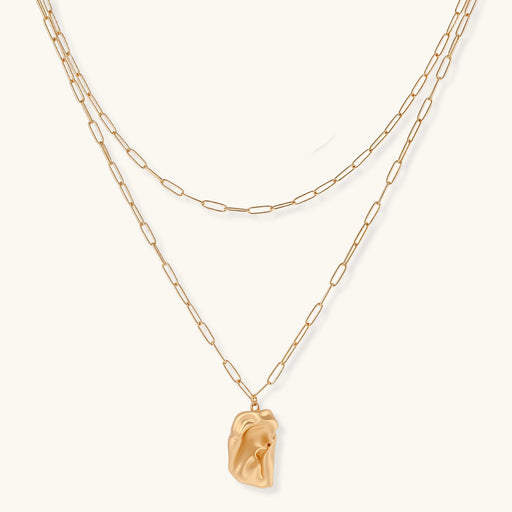 Layered paperclip chain necklace with organic flowing pendant made from eco-zinc alloy in warm gold finish