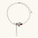Detailed eco-brass serpent pendant necklace with red zirconia stone and crystal drop tassel on adjustable chain