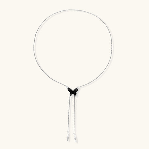 Wooden butterfly pendant necklace with cascading silver-toned chains on adjustable chain, available in amber and black.