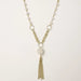 Long gold-plated necklace with freshwater pearls, chunky chain links, and flowing tassel pendant