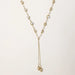 Adjustable gold lariat necklace with freshwater pearls nested in delicate cage settings and Y-shaped tassel drop