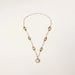 14K gold plated necklace with organic leaf motifs and freshwater pearls arranged in an elegant chain design on neutral background.