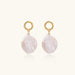 18K gold vermeil twisted circle studs with organic white baroque pearl drops on cream background