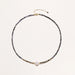 Dainty necklace with faceted purple iolite beads, gold vermeil accents, and central pink-white freshwater pearl.