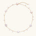 Gold vermeil chain with iridescent star-shaped baroque pearls and small round freshwater pearl drops on cream background.