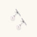 Rhodium-plated sterling silver ear jacket earrings with diamond-set horizontal bar and freshwater pearl drop