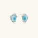 Oval larimar gemstone studs with ornate silver settings showing natural turquoise marbling on cream background