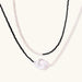 Double-strand necklace with black faceted quartz and white pearls featuring an oversized baroque pearl centerpiece