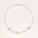 Delicate pearl necklace with pale green serpentine jade centerpiece and colorful agate beads on cream background