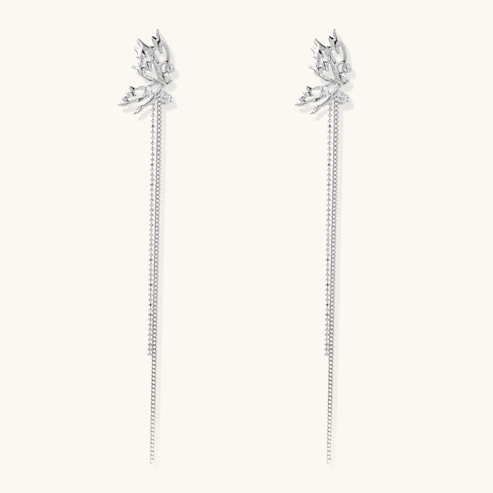 Silver-toned threader earrings featuring detailed fairy figure with wings and dual delicate chain strands, zirconia accents