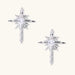 Silver starburst earrings with radiating points and dagger drop design featuring clear zirconia stones