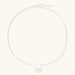 Minimalist brushed sterling silver dome pendant on delicate chain against cream background, showing matte textured finish