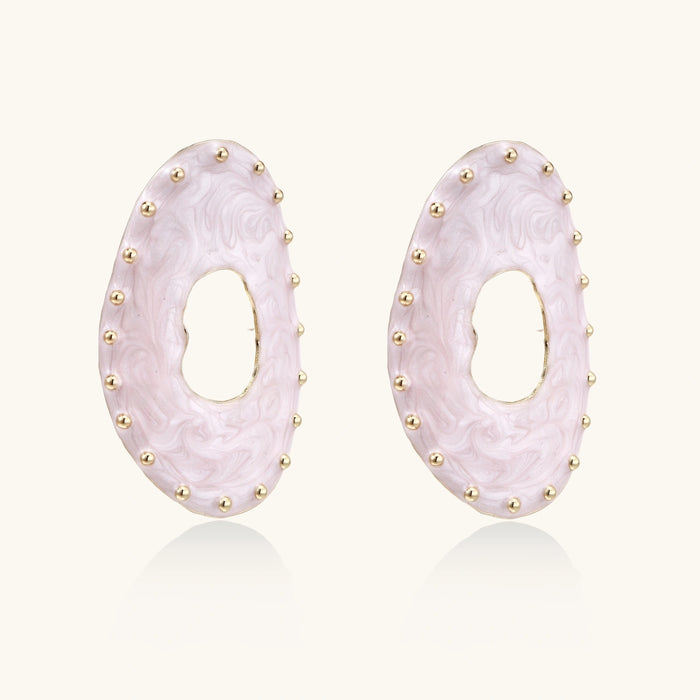 Oval lavender enamel earrings with marbled finish and gold-plated beaded border on cream background.