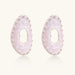 Oval lavender enamel earrings with marbled finish and gold-plated beaded border on cream background.