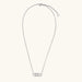 White gold plated necklace with dual-frame geometric pendant featuring crystal pavé border on pale background.