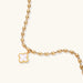 18K gold-plated oval bead chain bracelet with quatrefoil clover charm featuring mother of pearl inlay on cream background