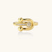 Gold-plated brass ring with safety pin design featuring pavé cubic zirconia stones and dual sphere ends